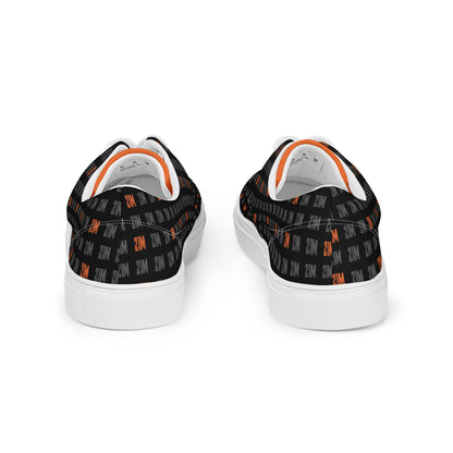 Black sneakers with orange patterns on a white background