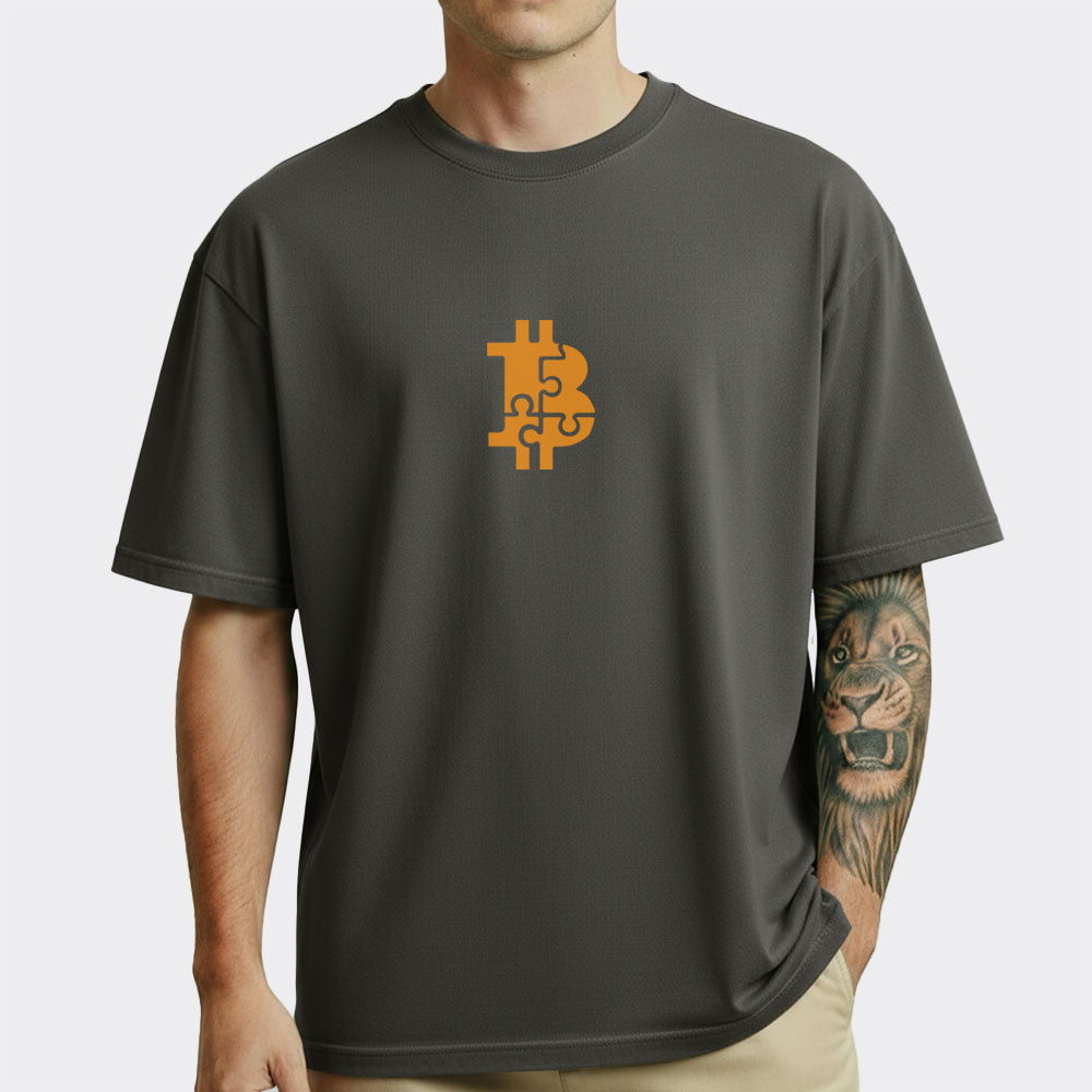 Person wearing a dark gray t-shirt with a gold Bitcoin symbol on a white background