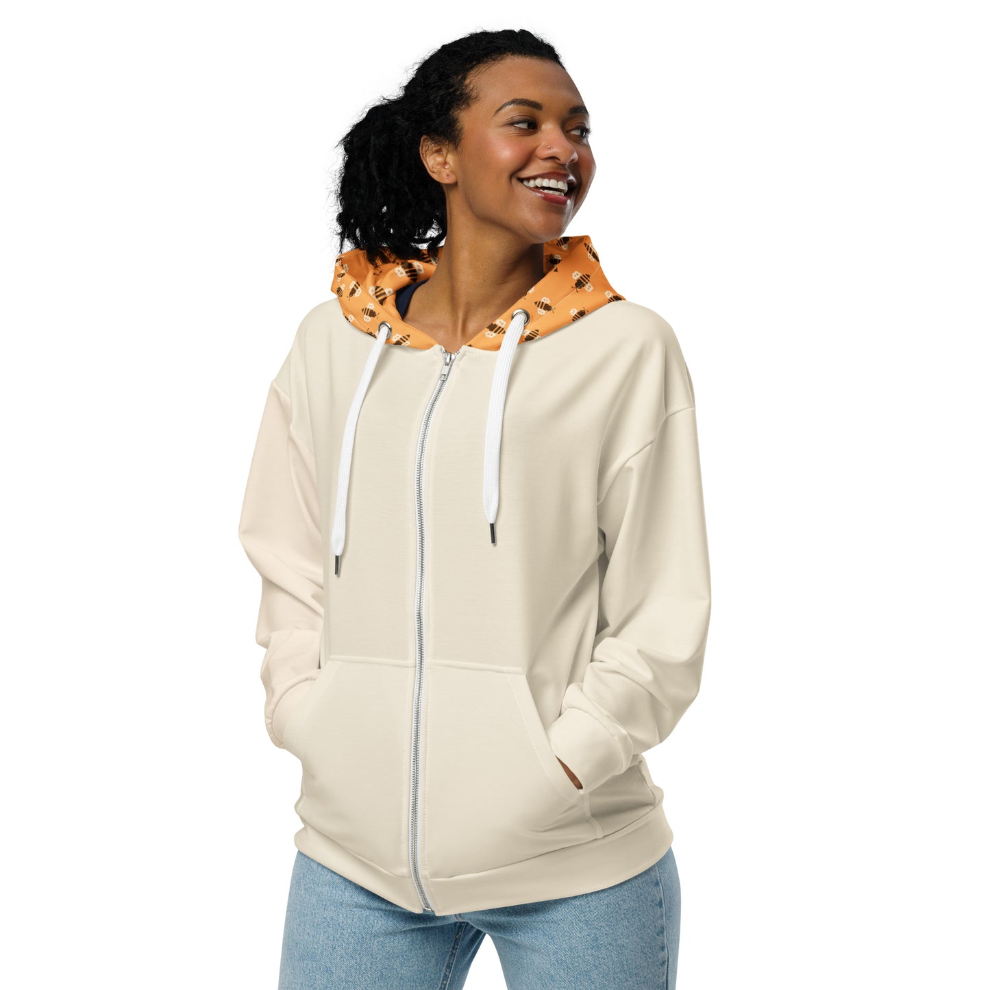 Woman wearing a beige hoodie with a colorful bitcoin bees hood on a white background
