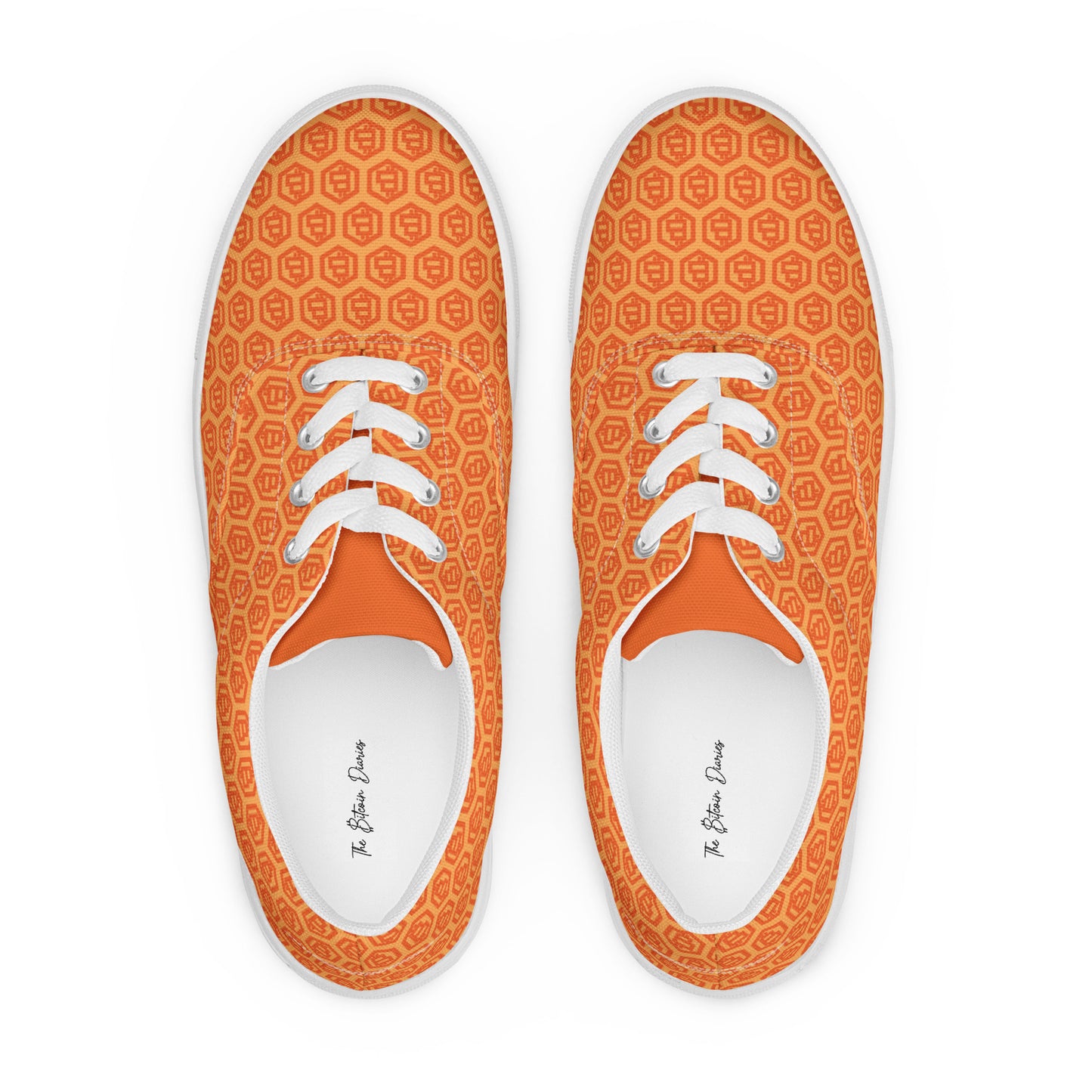 Pair of orange sneakers with bitcoin symbols white laces on a white background