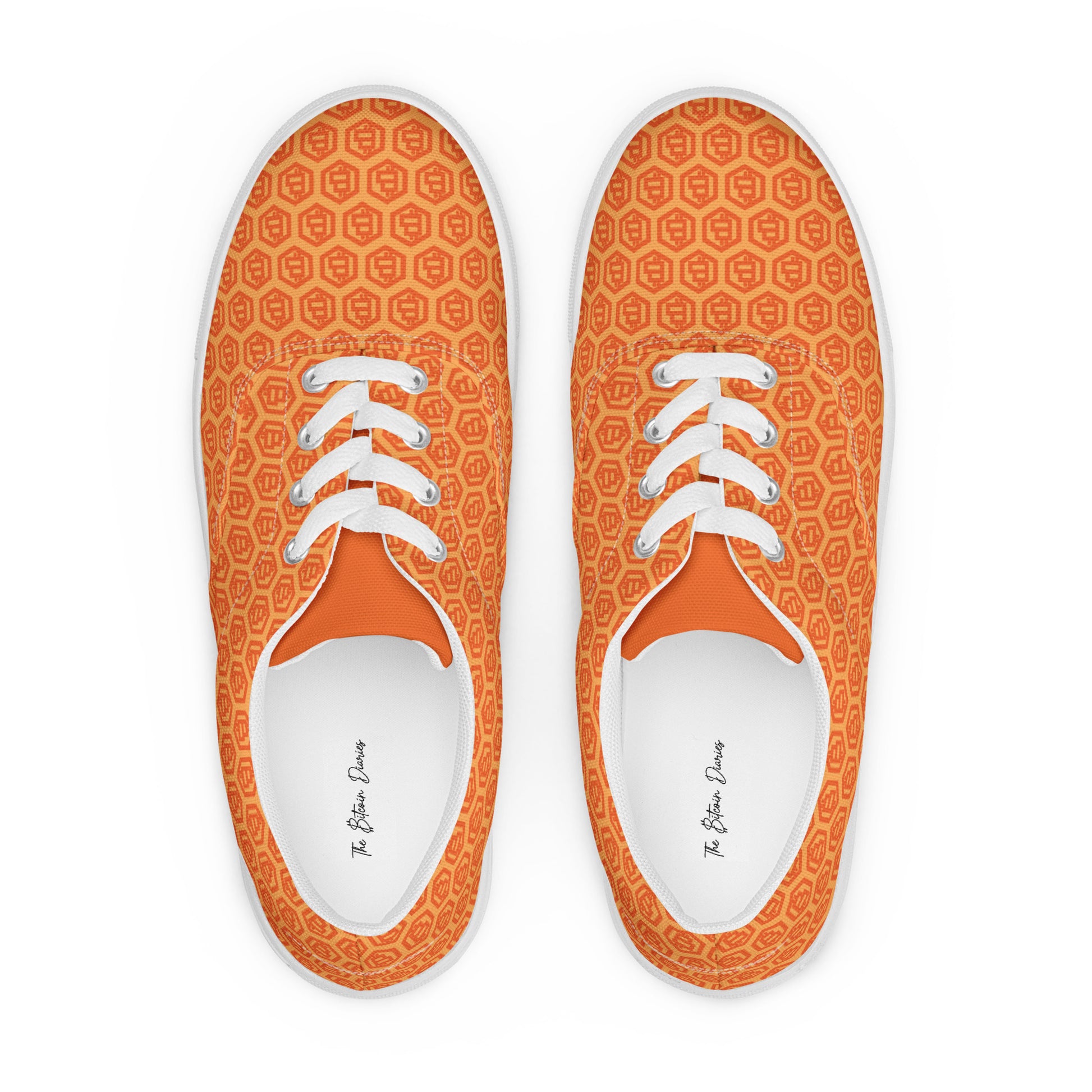 Pair of orange sneakers with bitcoin symbols white laces on a white background