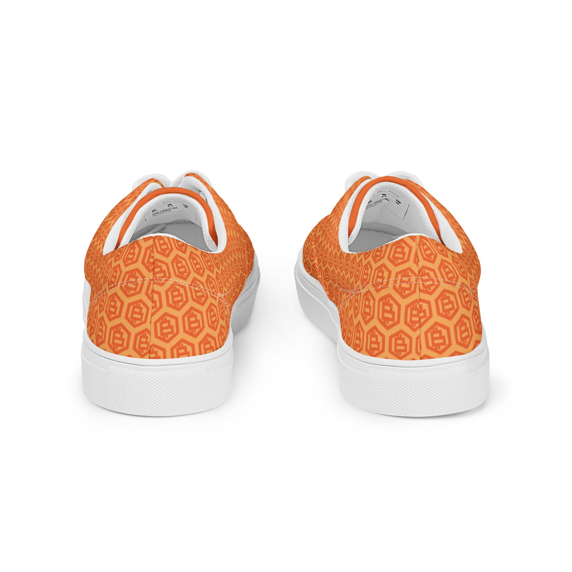 Orange patterned sneakers with white soles on a white background