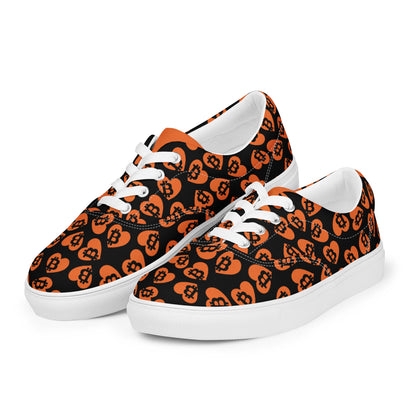 Pair of sneakers with orange and black bitcoin pattern on a white background