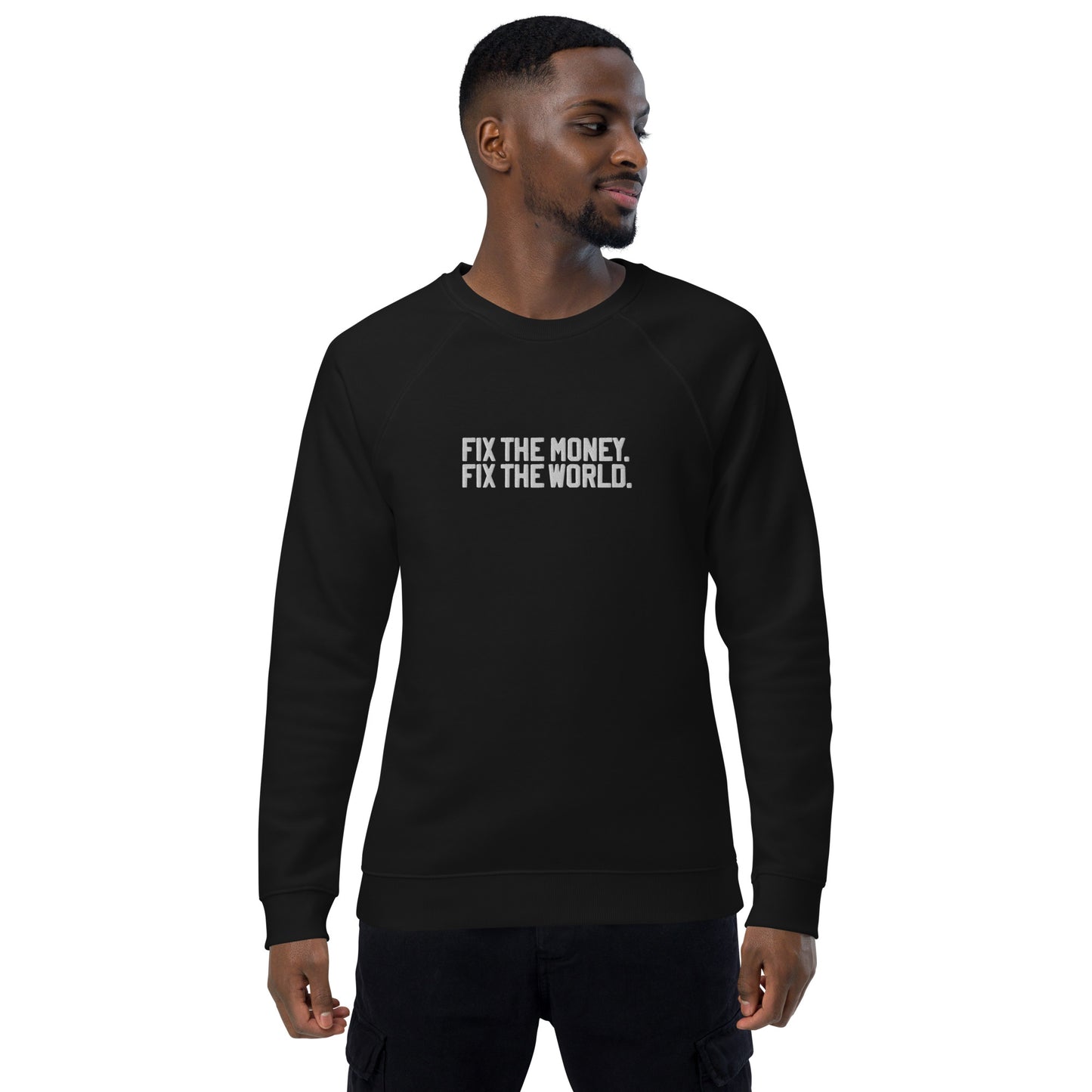 Man wearing a black sweatshirt with fix the money. fix the world. text on a white background