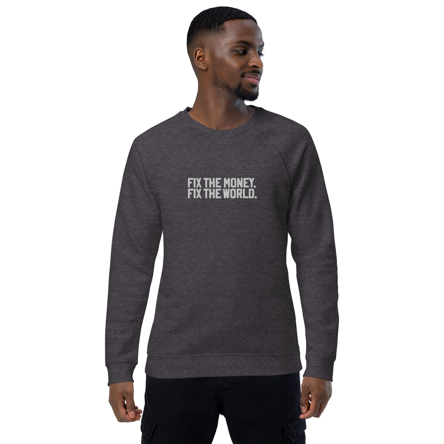 Man wearing a dark gray sweatshirt with fix the money fix the world. text on a white background