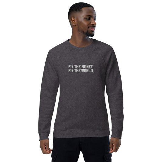 Man wearing a dark gray sweatshirt with fix the money fix the world. text on a white background