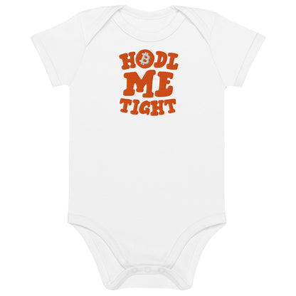 White baby onesie with 'HODL ME TIGHT' text in orange on a white background