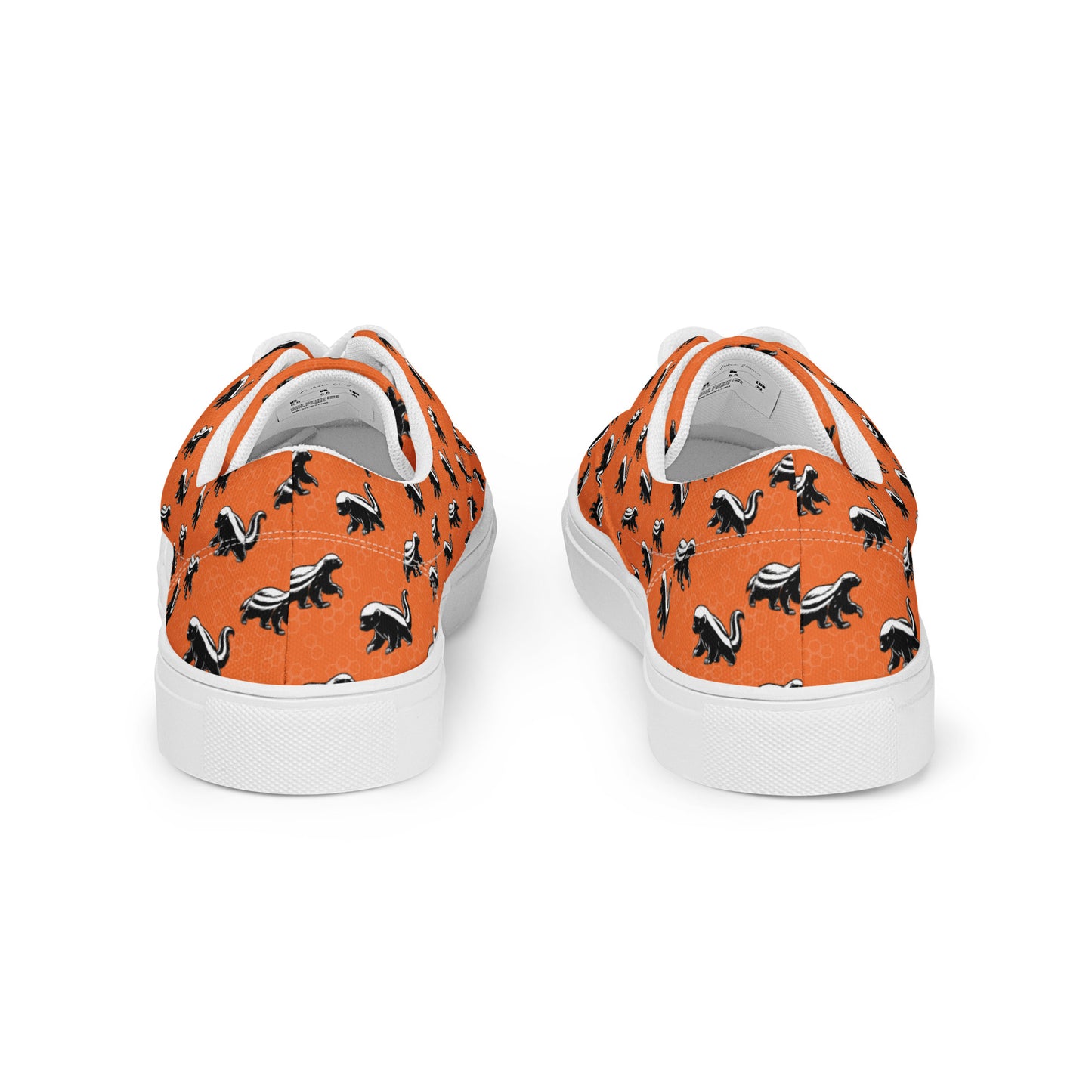 Orange sneakers with black animal pattern on a white background