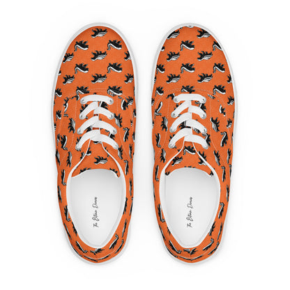 Orange sneakers with black and white honey badger pattern on a white background