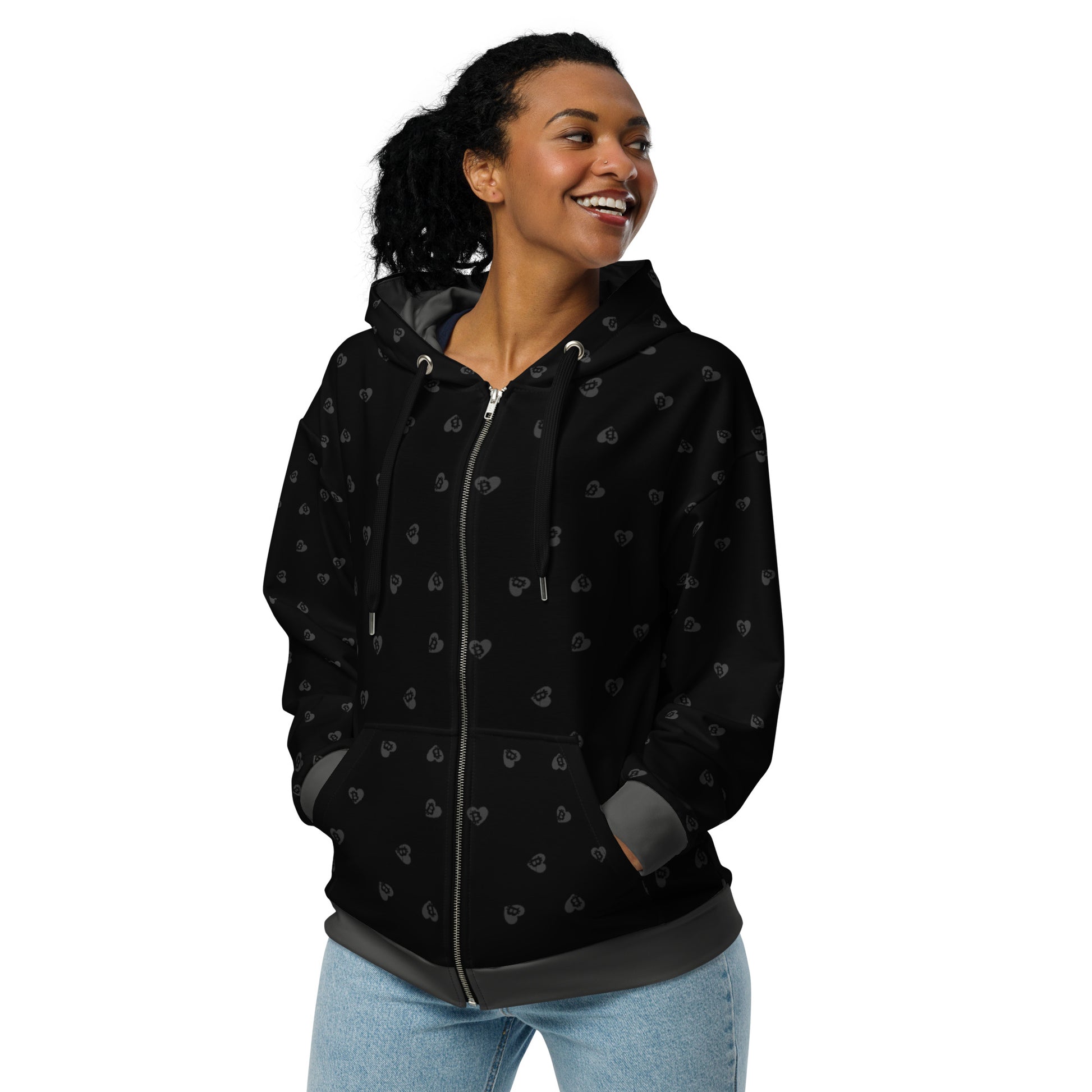 Woman wearing a black hoodie with small bitcoin hearts patterns on a white background