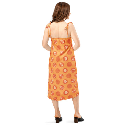 Woman wearing an orange dress with bitcoin tropical patterns on a white background