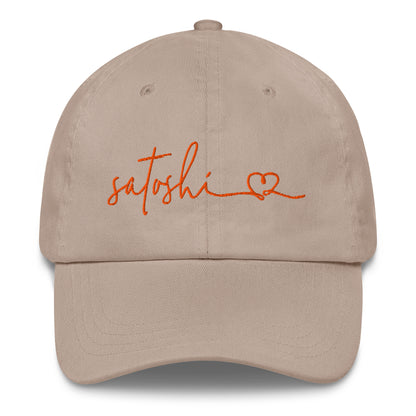 Beige cap with 'satoshi' and a heart embroidered in orange on a white background