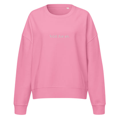 Pink sweatshirt with told you so text on a white background